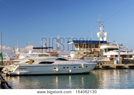 Private boat and yachts moored at pier in Sochi seaport. Marine station complex Port. Krasnodarskiy kray Russia