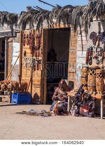WALVIS BAY NAMIBIA - JUNE 22 2016: Himba woman sells souvenirs in Walvis Bay Namibia.