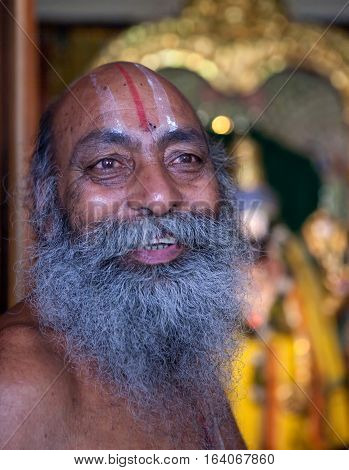 RISHIKESH, INDIA. 9 June 2009: Hindu Monk, Sadhu, worshipper of Shiva, at the entrance to the temple of Sri Trayambakeshwar. Rishikesh, India.