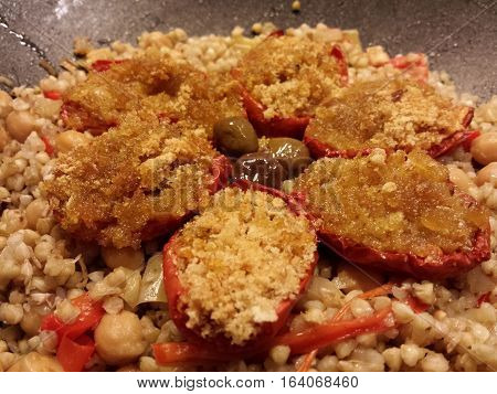 tomatoes stuffed with spelled, olives and chickpeas