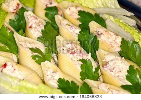 Traditional Italian conchiglioni rigati pasta stuffed with salad