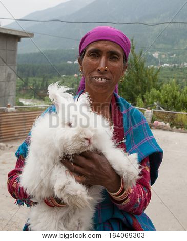 DHARAMSALA, INDIA. 2 Jun 2009: Rural residents in daily life. Hindu Woman with a white rabbit on hands. Western Himalayas, Himachal Pradesh, district of Kangra.