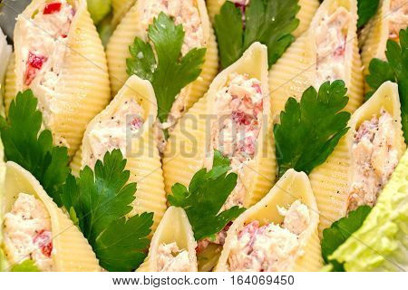 Traditional Italian conchiglioni rigati pasta stuffed with salad