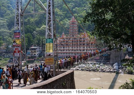 RISHIKESH, INDIA. 9 June 2009: The temple of Sri Trayambakeshwar and bridge Lakshmanjhula, Rishikesh, India.