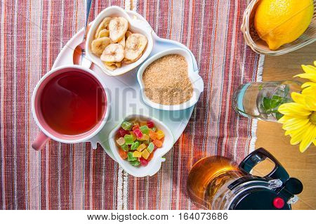 Top View Cup Of Hot Tea With Snacks On A Tray On The Served Table. Relax Breakfast Concept. Selectiv