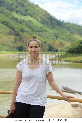 Asian young lady with river in backgroundcasual dresstravel concept.
