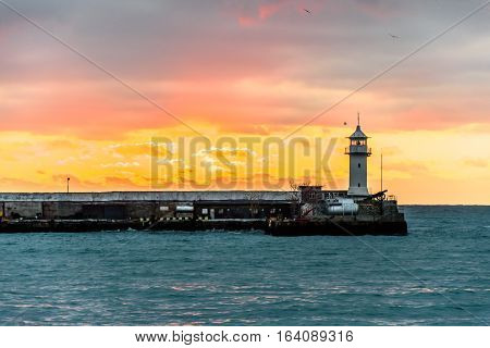 Lighthouse on the sea during the dawn. Yalta, Crimea.