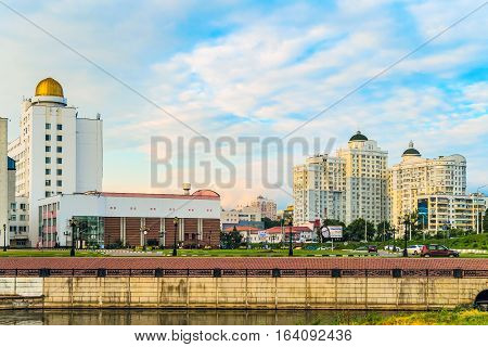 BELGOROD RUSSIA - JULY 04 2016: City embankment of the river Vezelka. The campus of the Belgorod State University. Detail of the main building of university with observatory and residential complex 
