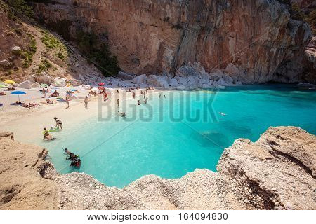 SARDEGNA ITALY - 24 June 2016: People on the beatiful beach Cala Mariolu bay BAUNEI SARDEGNA