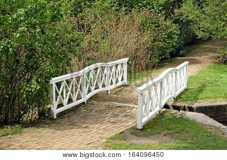 TARKHANI RUSSIA - AUGUST 28 2016: Bridge through the channel between the two ponds in the Lermontov estate Tarkhany