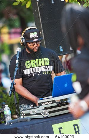 ATLANTA, GA - OCTOBER 2016:  A deejay uses sophisticated electronics to enhance the audio and play rap music at the Atlanta Hip Hop Day a free event open to the public in Woodruff Park in Atlanta GA on October 8 2016.