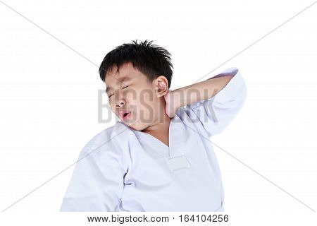 Accidents in sports. Asian child athletes taekwondo have a neck pain. Isolated on white background. Boy lie down and groaning with a painful gesture. Studio shot.