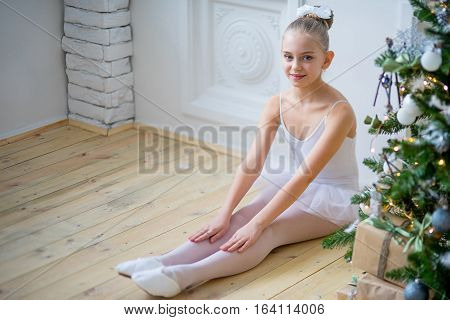 Young Ballet Dancer Sitting Near Christmas Tree