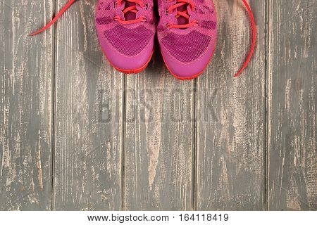 Trainers on wood floor. Stock photo Sporty mock up