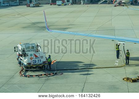 BANGKOK, THAILAND - DEC 29 2016. airport officer and truck Refueling of the aircraft at Don Mueang international airport (DMK)