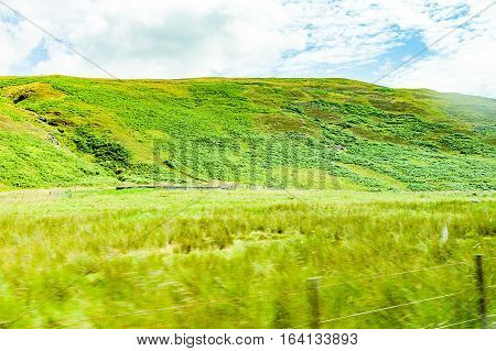 landscapes of agricultural fields photographed from the car near blackford town in the Highlands Scotland
