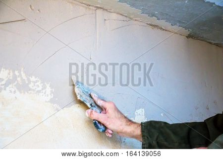 Man plastering wall with spatula. Wall finish 2