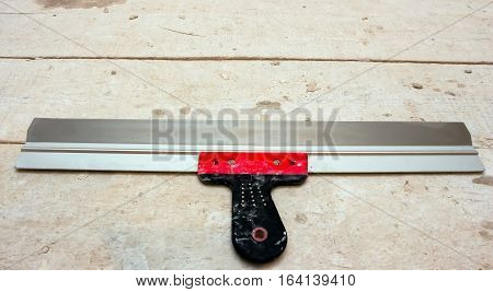Used large spatula on old dirty building materials boards