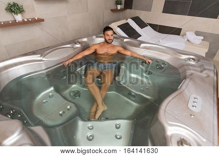 Handsome Relaxed Man In Jacuzzi Spa
