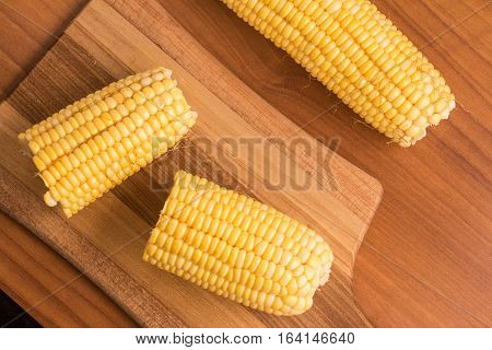 Corn Cob. Milho Verde over a wooden table