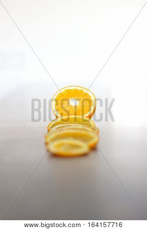 deliciously sweet ripe orange cut into slices laid on a shiny bar board