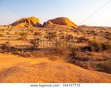 Landscape around Spitzkoppe, aka Spitzkop, with massive granite rock formations, Namib Desert in Namibia, Africa.