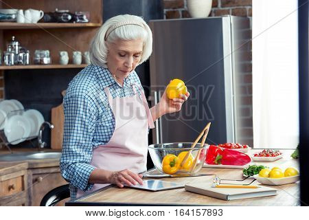 Woman Using Digital Tablet In Kitchen