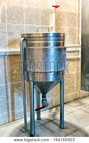 New stainless steel beer fermenter in brewery
