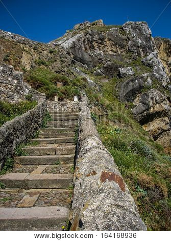 Gastelugache -  island on  coast of  Bay of Biscay belonging to  municipality of Bermeo, Basque Country.  Island is connected to  mainland by  man-made bridge that goes into  winding staircase that spans 237 degrees.