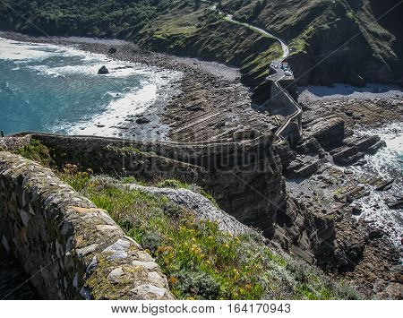 Gastelugache -  island on  coast of  Bay of Biscay belonging to  municipality of Bermeo, Basque Country.  Island is connected to  mainland by  man-made bridge that goes into  winding staircase that spans 237 degrees.