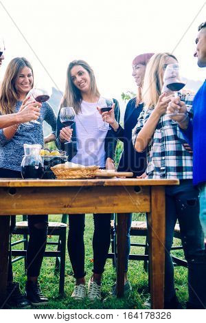 Group of friends at restaurant outdoors - People having dinner in a home garden