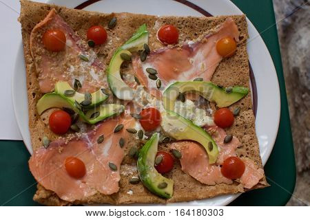Crepe filled with Tomatoes, avocado , smoked salmon lox, brie cheese and pumpkin seeds