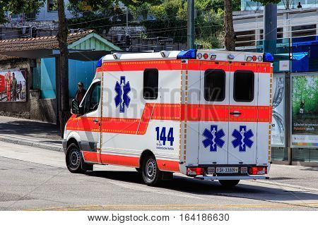 Schaffhausen, Switzerland - 26 August, 2015: an ambulance van parked on Bahnhofstrasse street at the Schaffhausen railway station. In Switzerland the phone number for the ambulance is 144, as painted on the van.