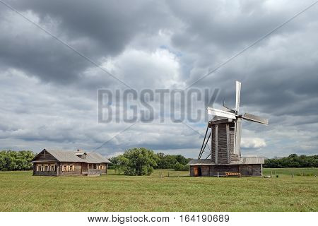 TARKHANI RUSSIA - AUGUST 28 2016: Wooden windmill and barn in the Lermontov estate Tarkhani