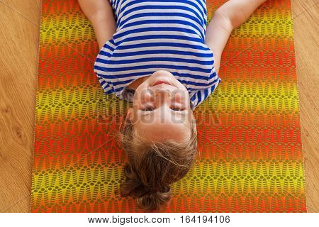Little boy on a yoga class with a beautiful yoga mat