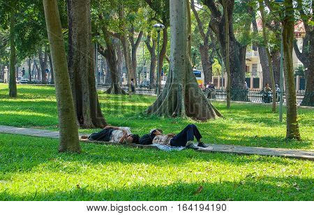 Siesta in the park at Hoan Kiem Lake in Hanoi, Vietnam