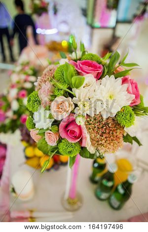 a bouquet of flowers in a vase on the table