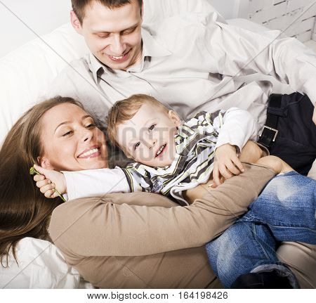 young happy modern family smiling together at home. lifestyle people concept, father holding baby son close up