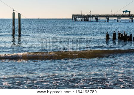 Buckroe Beach in Hampton, Virginia with fishing pier in background.