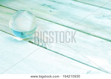 Abstract picture of glass ball on wooden floor pastel color idea of fortune the best future for background greeting cards happiness festival New years wishes Valentine day
