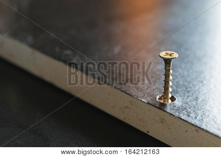 A screw drilling on a side of the part of wooden to assembly boxes the idea of doing it yourself for home decoration.