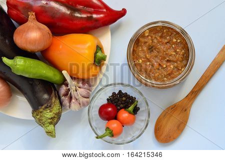 Ajvar roasted sweet pepper and eggplant (aubergine) with the ingredients, top view