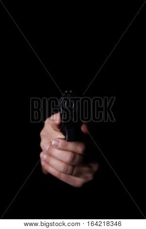 Closeup view of man's hands aiming with gun.