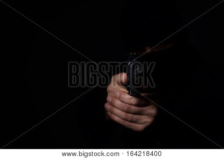Closeup view of man's hands aiming with gun.