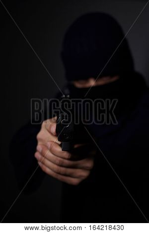 Closeup view of man's hands aiming with gun.