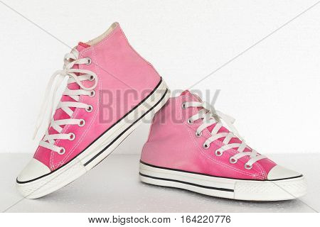 close up vintage style of sport pink gradient sneaker shoes on white background