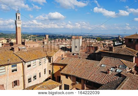 Siena, Italy - October 8, 2014. View over Siena, Italy with Palazzo Comunale on the left, with rooftops of historic buildings.