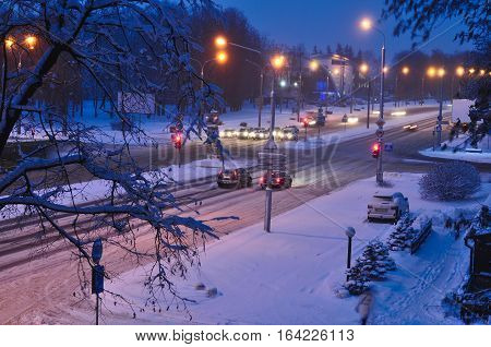 Top view to avenue covered with snow in early morning or evening. Winter snow disaster in a city. snowstorm on a road cars in snow. blue and yellow colors