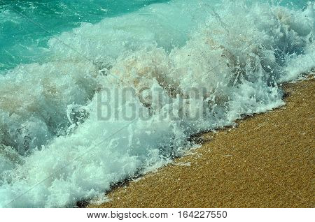 relax sunbathe travel transience concept. aquamarine blue sea ocean waves of water with white foam falling on golden sand background.