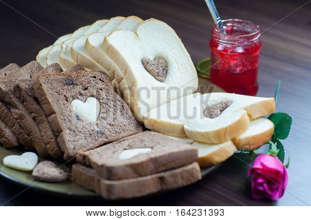 photo love bread. bread valentine. photo love delicious slice of bread with strawberry jam sweetener. is suitable for decorating the nuances of affection